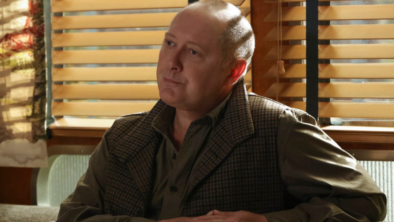 Red Reddington sitting at restaurant table in The Blacklist