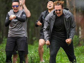 Former NFL athlete Luke Willson (right) celebrates with his team on the set of the reality TV show Canada's Ultimate Challenge.