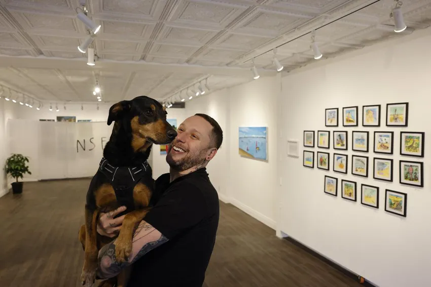 Zack Rosen at the Northern Contemporary Gallery with the gallery's dog Piper. Rosen's next project is a series of paintings of dog parks.